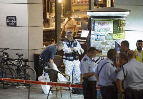 epa05352113 Police inspectors work at the scene of a shooting outside Max Brenner restaurant in Sarona market in Tel Aviv, Israel, 08 June 2016. According to reports, at least three people were killed and five seriously injured in a shooting in Tel Aviv's Sarona complex. EPA/JIM HOLLANDER