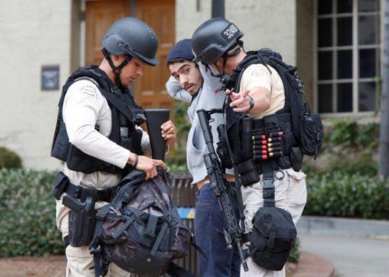 Police officers search a student's belongings at the University of California, Los Angeles (UCLA) campus after it was placed on lockdown following reports of a shooter in Los Angeles, California June 1, 2016. REUTERS/Patrick T. Fallon